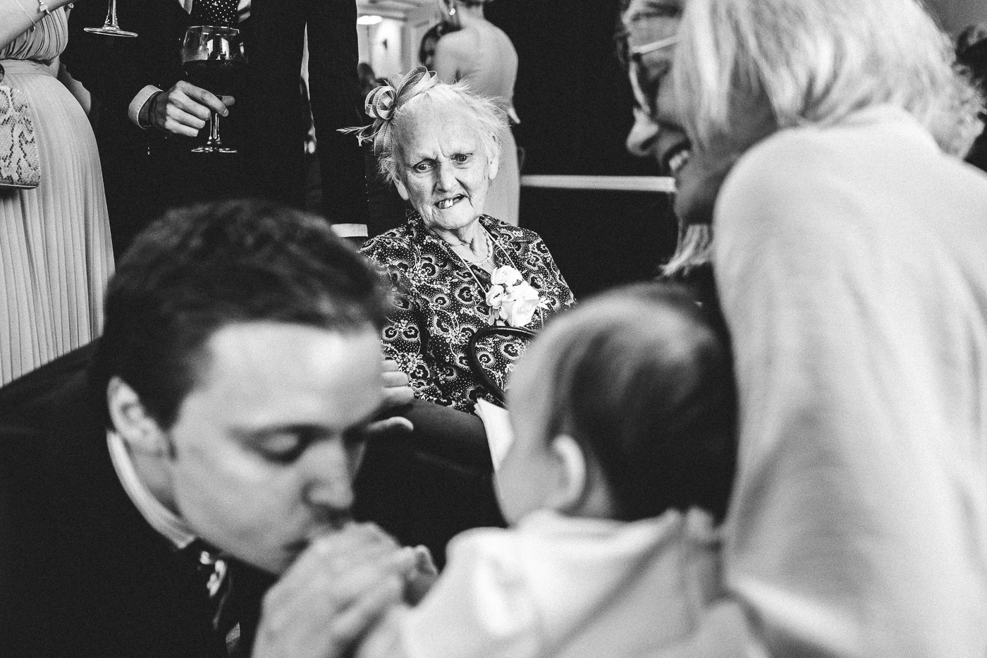 great-grandma looks at the baby at the wedding at the old palace in chester